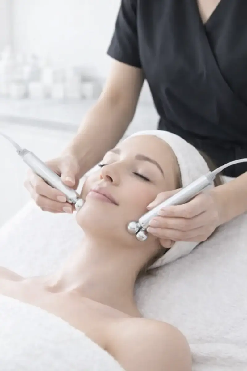 Charlotte performing a microcurrent facial
