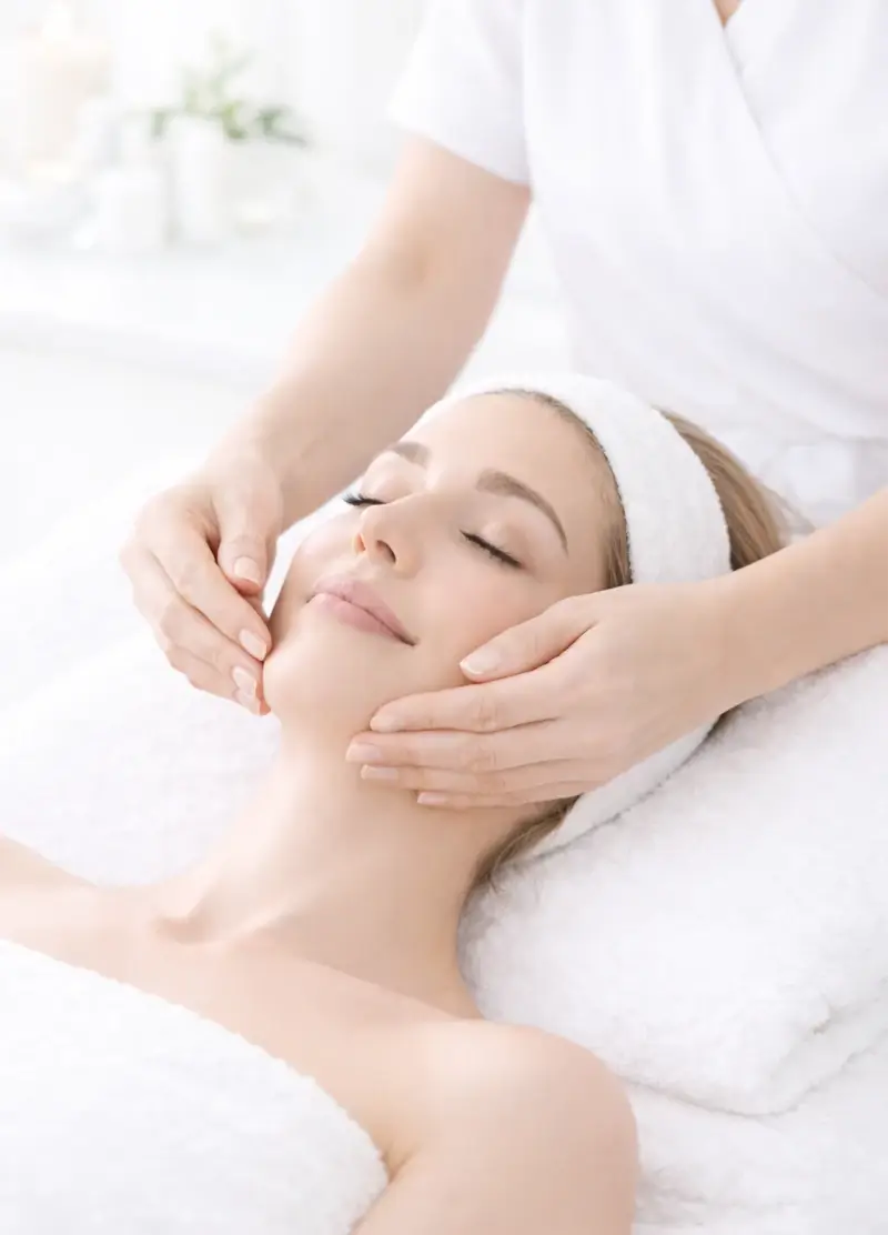 Charlotte performing a natural lift facial on a client